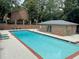 Well-maintained community pool with a brick pool house and lounge chairs at 70 Old Ivy Ne Rd # 29, Atlanta, GA 30342