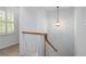 Staircase with wood railing and balusters, with modern light fixture at 70 Old Ivy Ne Rd # 29, Atlanta, GA 30342