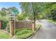 Scenic street corner with mature trees and decorative entrance at 70 Old Ivy Ne Rd # 29, Atlanta, GA 30342
