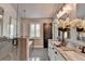 Bright bathroom featuring double vanity, granite countertops, framed mirrors, and a walk-in shower at 7725 Pierpoint Ln, Alpharetta, GA 30005