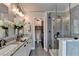 Modern bathroom features dual sinks, a granite countertop, a glass-enclosed shower, and stylish fixtures at 7725 Pierpoint Ln, Alpharetta, GA 30005