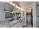 Modern bathroom features dual sinks, a granite countertop, a glass-enclosed shower, and stylish fixtures at 7725 Pierpoint Ln, Alpharetta, GA 30005