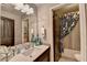 Bright bathroom featuring a dark wood door, decorative mirror, and shower/tub combo with a stylish curtain at 7725 Pierpoint Ln, Alpharetta, GA 30005