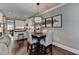 Cozy dining area features a modern light fixture, dark table and stylish zebra-patterned chairs at 7725 Pierpoint Ln, Alpharetta, GA 30005