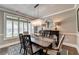 Elegant dining room featuring a modern chandelier, dark wood table, and shutters for natural light at 7725 Pierpoint Ln, Alpharetta, GA 30005