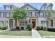 Charming townhome featuring brick and siding accents, complemented by mature landscaping and inviting entryway at 7725 Pierpoint Ln, Alpharetta, GA 30005
