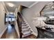 Hallway showcasing hardwood floors, staircase with carpeting, and stylish lighting at 7725 Pierpoint Ln, Alpharetta, GA 30005