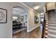 Hallway with an open archway leading to a dining room with stylish lighting and decor at 7725 Pierpoint Ln, Alpharetta, GA 30005