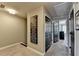 Hallway with a decorative sign, neutral carpet, and multiple closet doors for ample storage at 7725 Pierpoint Ln, Alpharetta, GA 30005