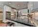 Spacious kitchen features stainless steel appliances, white cabinets, and dark countertops, ideal for cooking at 7725 Pierpoint Ln, Alpharetta, GA 30005