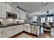 Open kitchen layout with white cabinets, stainless steel appliances, and easy access to the dining area at 7725 Pierpoint Ln, Alpharetta, GA 30005
