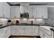 Beautiful kitchen with white cabinets, stainless appliances, and subway tile backsplash for modern convenience at 7725 Pierpoint Ln, Alpharetta, GA 30005