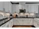 Well-equipped kitchen features white cabinets, stainless appliances, and subway tile backsplash for modern cooking at 7725 Pierpoint Ln, Alpharetta, GA 30005
