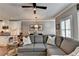 Cozy living room with a comfortable gray sofa, kitchen, and a view of the dining area at 7725 Pierpoint Ln, Alpharetta, GA 30005