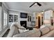 Inviting living room featuring built-in bookshelves, a cozy fireplace, and comfortable seating at 7725 Pierpoint Ln, Alpharetta, GA 30005