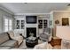 Inviting living room featuring built-in bookshelves, a cozy fireplace, and comfortable seating at 7725 Pierpoint Ln, Alpharetta, GA 30005