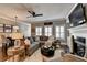 Comfortable living room with a fireplace, plush seating, ceiling fan, and elegant decor at 7725 Pierpoint Ln, Alpharetta, GA 30005
