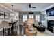 Open-concept living room featuring a fireplace, plush seating, and a dining area with modern lighting at 7725 Pierpoint Ln, Alpharetta, GA 30005
