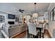 Inviting living room with fireplace, built-in shelves, open layout, and adjoining kitchen and dining area at 7725 Pierpoint Ln, Alpharetta, GA 30005