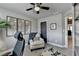 Comfortable office space features neutral walls, a ceiling fan, and a cozy chair with throw at 7725 Pierpoint Ln, Alpharetta, GA 30005