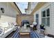 Cozy patio space with comfortable seating, string lights, and a brick accent wall at 7725 Pierpoint Ln, Alpharetta, GA 30005