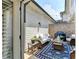 Private outdoor patio featuring comfortable seating, string lights, and a barbecue grill at 7725 Pierpoint Ln, Alpharetta, GA 30005