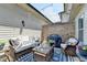 Outdoor patio with cozy seating, grill, decorative rug, and charming string lights at 7725 Pierpoint Ln, Alpharetta, GA 30005