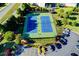 Aerial view of the community tennis courts with parking, surrounded by lush landscaping in Jamestown at 7725 Pierpoint Ln, Alpharetta, GA 30005