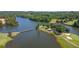 Scenic aerial of the golf course featuring water features, lush greenery, and a charming bridge at 9889 Between The Grns, Villa Rica, GA 30180