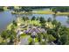 Stunning aerial view of a golf course community featuring a waterfront home, surrounded by lush greenery and mature trees at 9889 Between The Grns, Villa Rica, GA 30180