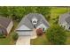 Aerial view of a single-story home with well-maintained landscaping, a two-car garage, and a classic white exterior at 9889 Between The Grns, Villa Rica, GA 30180