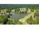 Scenic aerial view of a golf course community with a tranquil lake, surrounded by mature trees and lush greenery at 9889 Between The Grns, Villa Rica, GA 30180
