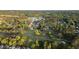 Picturesque aerial view of the community golf course surrounded by lush trees and residential homes at 9889 Between The Grns, Villa Rica, GA 30180