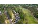Aerial view of homes nestled next to a golf course, surrounded by lush trees at 9889 Between The Grns, Villa Rica, GA 30180