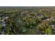Beautiful aerial view showcasing the golf course and neighborhood nestled within a dense forest landscape at 9889 Between The Grns, Villa Rica, GA 30180