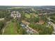 Aerial view of a residential area with lush trees, a golf course, and winding roads at 9889 Between The Grns, Villa Rica, GA 30180