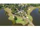 Expansive aerial view of a golf course community with water access, showcasing mature trees and serene surroundings at 9889 Between The Grns, Villa Rica, GA 30180