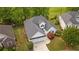 Aerial view of a single-story home with well-maintained landscaping, a two-car garage, and a classic white exterior at 9889 Between The Grns, Villa Rica, GA 30180