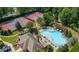 Aerial view showcases community pool, tennis courts, and landscaped grounds creating an inviting recreational atmosphere at 9889 Between The Grns, Villa Rica, GA 30180