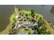 An aerial view showcases a beautiful property with a circular driveway near a golf course and lake at 9889 Between The Grns, Villa Rica, GA 30180