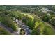 Aerial view of homes nestled next to a golf course, surrounded by lush trees at 9889 Between The Grns, Villa Rica, GA 30180