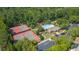 A vibrant aerial view captures tennis courts, a community pool, and parking nestled in a verdant, tree-lined setting at 9889 Between The Grns, Villa Rica, GA 30180