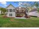 Well maintained lawn leading up to the home which features a raised deck and ground level patio at 9889 Between The Grns, Villa Rica, GA 30180