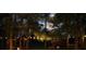 Cozy backyard with a firepit and hanging lights, creating a serene and magical outdoor ambiance at 9889 Between The Grns, Villa Rica, GA 30180
