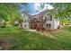 Expansive backyard with multi-level deck, patio, and lush green lawn, perfect for outdoor enjoyment at 9889 Between The Grns, Villa Rica, GA 30180