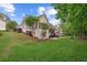 Spacious backyard featuring a two-story deck, manicured lawn, and mature trees at 9889 Between The Grns, Villa Rica, GA 30180