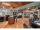 Spacious finished basement with a coffered ceiling, hardwood floors, and a small kitchen at 9889 Between The Grns, Villa Rica, GA 30180