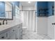 Stylish bathroom with a patterned floor, blue accents, and a shower-tub combination at 9889 Between The Grns, Villa Rica, GA 30180