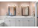 Bright bathroom featuring double vanity, framed mirrors, stylish lighting, and decorative accents at 9889 Between The Grns, Villa Rica, GA 30180