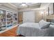 Comfortable bedroom with bookshelves, hardwood floors, and a soft, inviting bedspread at 9889 Between The Grns, Villa Rica, GA 30180